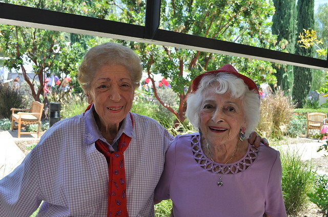 Two senior wearing red hat and red necktie